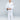 A young boy stands barefoot on a plain background, wearing the All Around Kids BJJ Gi White with a sleeve patch. He holds the front of his gi and looks directly at the camera with a neutral expression.