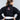 A person with brown hair in a ponytail wears the All Around Kids BJJ Gi Black and a white belt, standing with hands on hips and facing away from the camera.