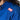 Close-up of a person wearing the Womens Competition BJJ Gi Blue, featuring a red and white FUJI patch on the shoulder. The person's long dark hair is partially visible.