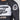 A person wearing a Fuji Jiu Jitsu Script Flex Lite Long Sleeve Rashguard in black, featuring a stylized American flag patch on the upper sleeve.