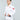A young boy confidently models the Kids Competition BJJ Gi White, holding his white belt ends with both hands against a plain light gray background.