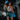 Woman in athletic wear and blue boxing gloves in a gym setting