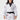 A woman smiles while wearing the Womens Flow-Tech BJJ Gi in white with pink and teal accents and a black belt, standing against a plain white background.
