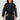 A woman wears the Womens Flow-Tech BJJ Gi Black/Gold with a black belt, standing against a plain white background, smiling with her hands relaxed by her sides.