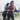 Two women in athletic wear standing on a balcony with a cityscape view.