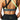 A woman wearing a gray sports bra with green accents and a BAD CAT logo